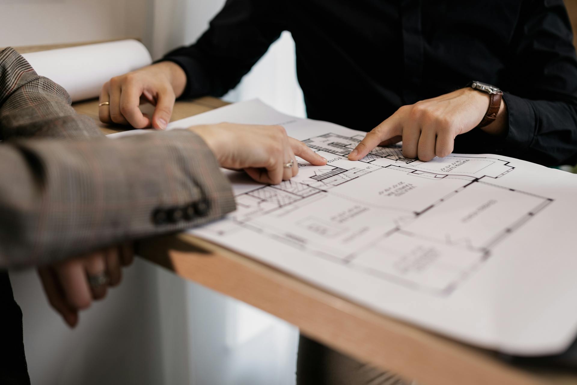 Two people doing an overview of a blueprint.