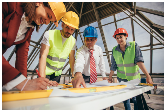 Workers looking at a blueprint.